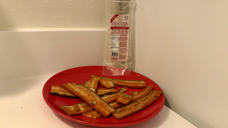 A plate of prepared Thrilling Bakon in front of its empty packaging