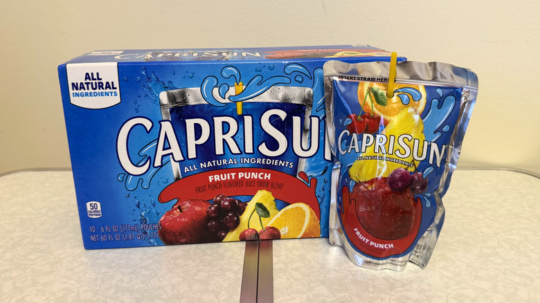 Capri Sun Fruit Punch juice pouch beside its box