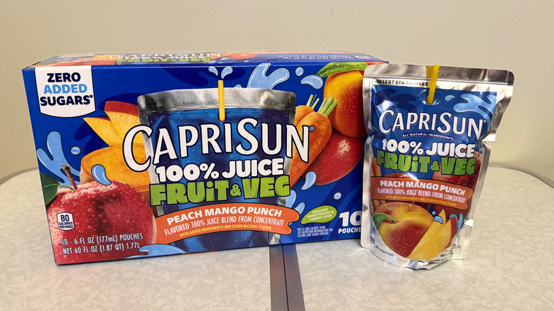 Capri Sun Peach Mango Punch juice pouch beside its box