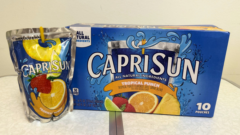 Capri Sun Tropical Punch juice pouch beside its box
