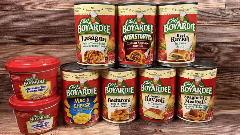 Various canned and unopened Chef Boyardee products stacked together