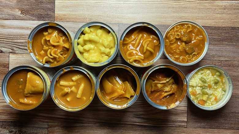 Two rows of open cans of Chef Boyardee products