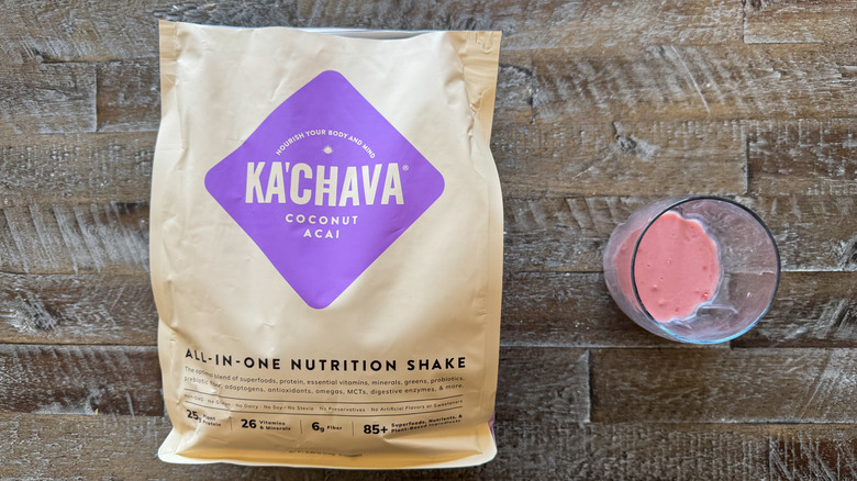 package and cup of Ka'Chava Coconut Açaí Nutrition Shake mix on wooden surface