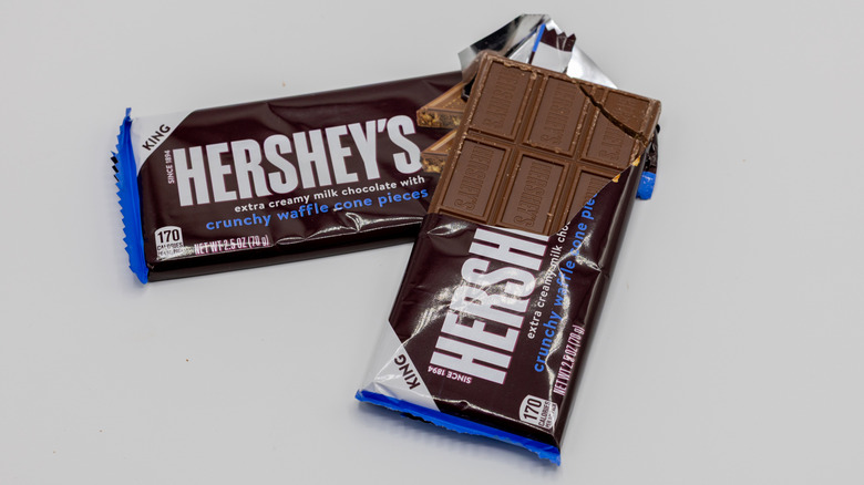 Two bars of Hershey's Milk Chocolate with Crunchy Waffle Cone Pieces on white background