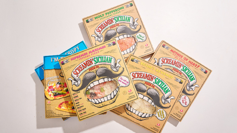 Seven Screamin' Sicilian pizza boxes stacked on a table