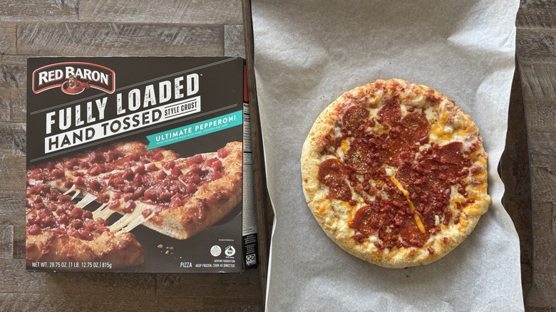 Pizza on pan with a box