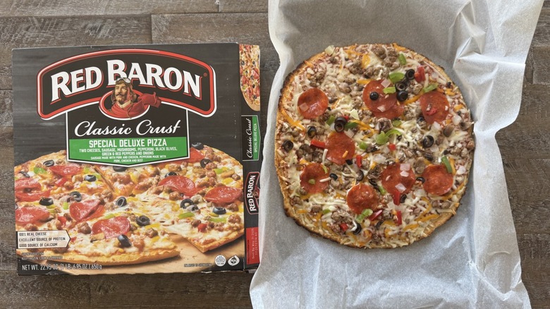 Pizza on pan with a box