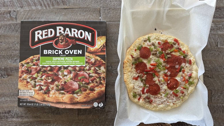 Pizza on pan with a box