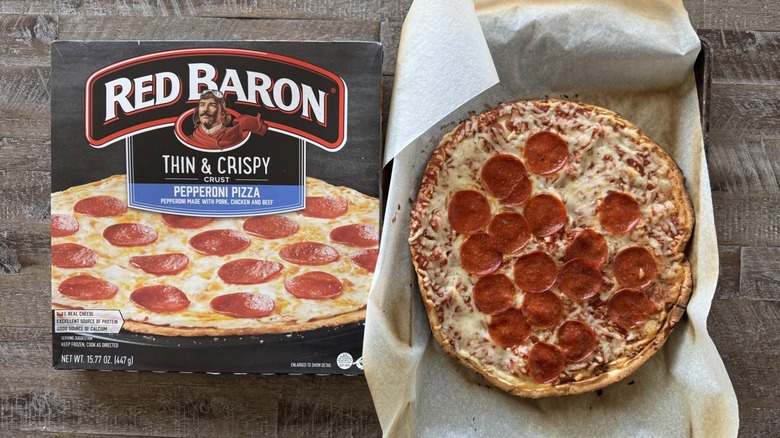 Pizza on pan with a box