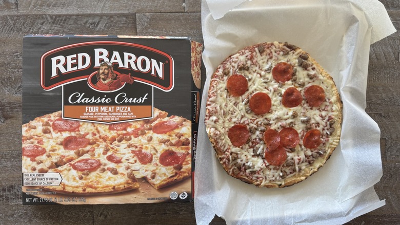 Pizza on pan with a box