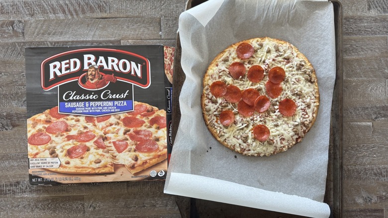 Pizza on pan with a box