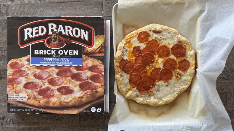 Pizza on pan with a box