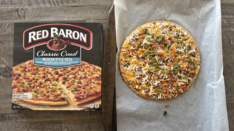 Pizza on pan with a box
