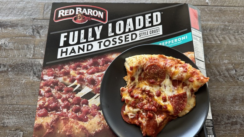 Pizza on pan with a box