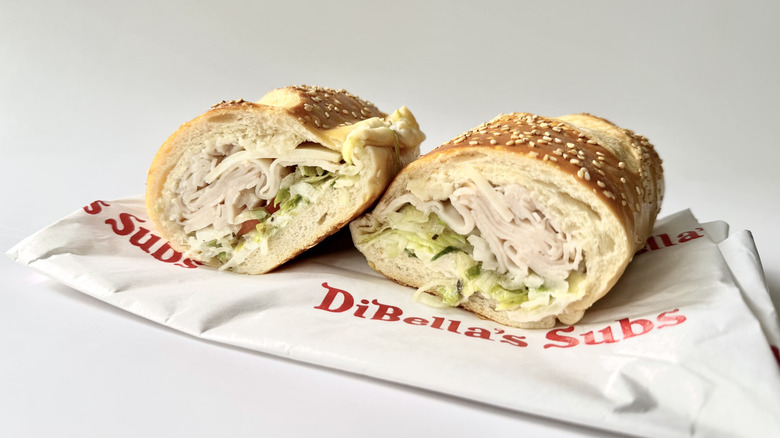 DiBella's Turkey Sub with its wrapping on a white background