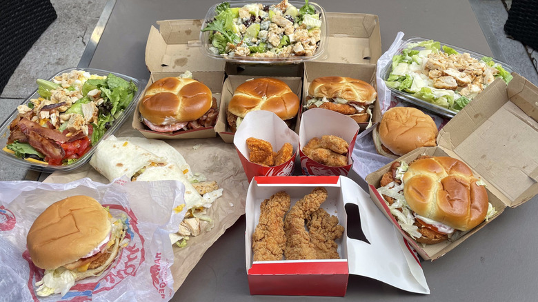 A selection of 13 chicken items from Wendy's sit on a table.