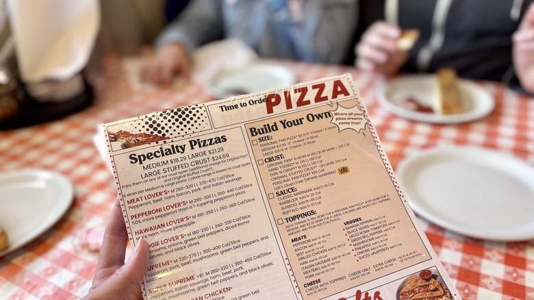 Pizza Hut menus held in a stack