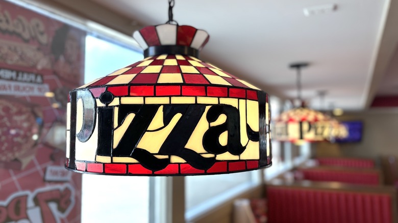 Pizza Hut Tiffany lamps hanging in a row above booths