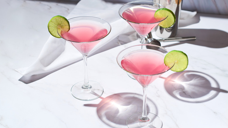 Pink cosmopolitan martinis garnished with lime