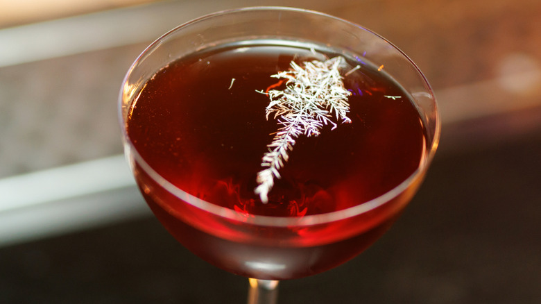 Coup cocktail glass with drink inside