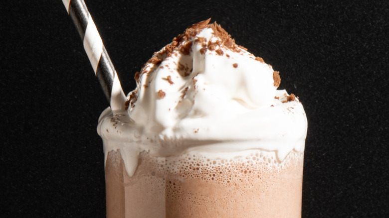 Single chocolate milkshake against black backdrop
