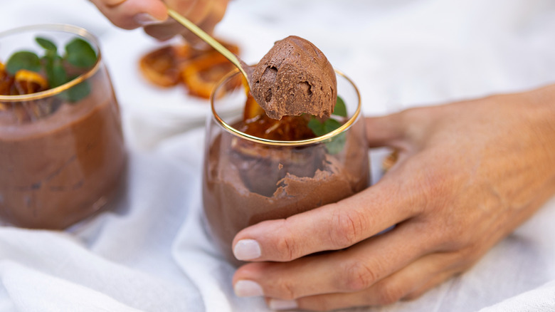 Spoon lifting bite of chocolate mousse