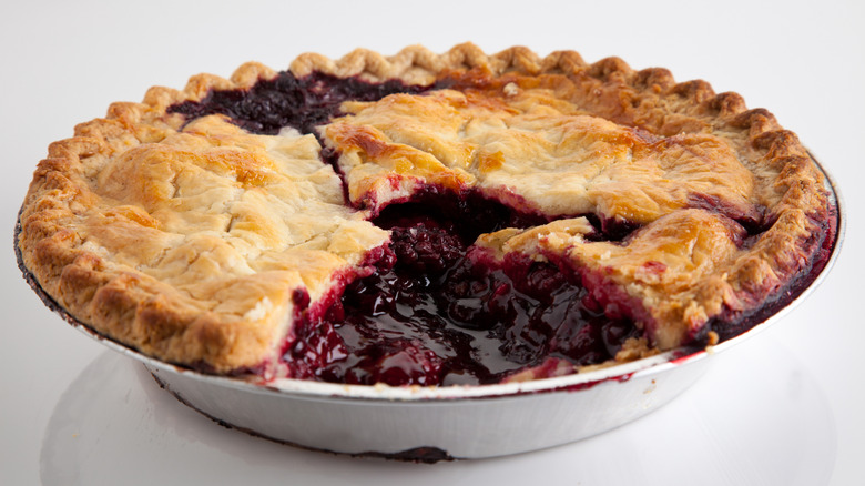 Boysenberry pie on gray background