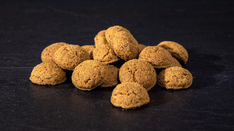 A pile of peppernuts on black background