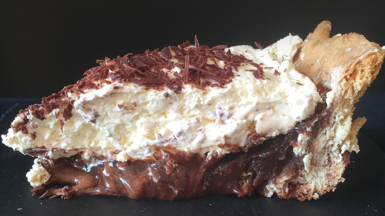 A slice of Mississippi mud pie on black background