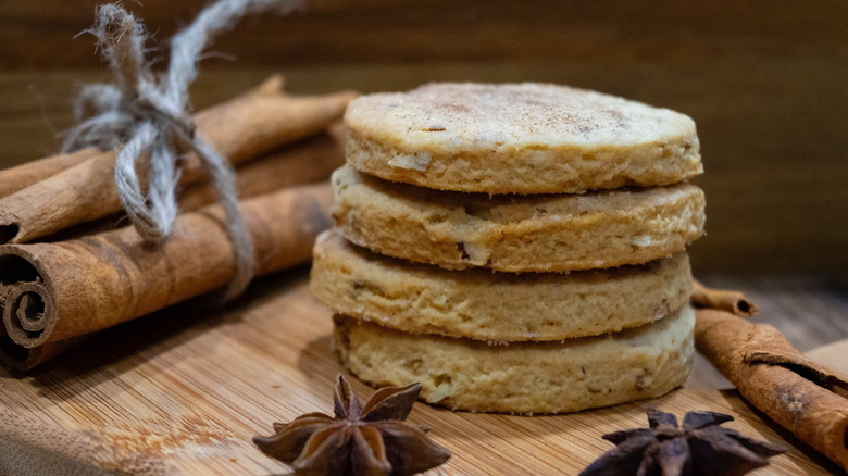 A stack of biscochitos with spices in the background