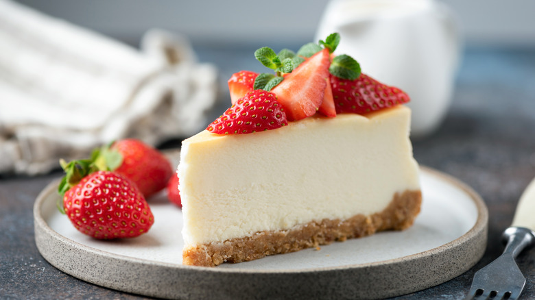 A slice of cheesecake with strawberries