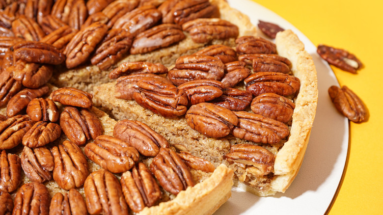 Pecan pie on yellow background