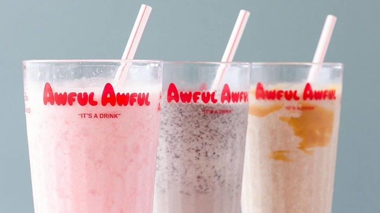 Three glasses of different Awful Awful flavors