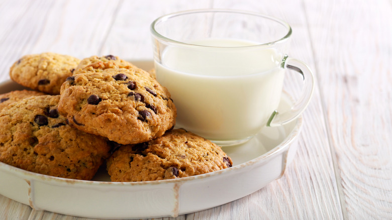 Plate of cowboy cookies and a glass of milk