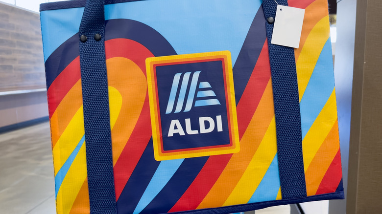 An Aldi shopping bag is printed in many colors.
