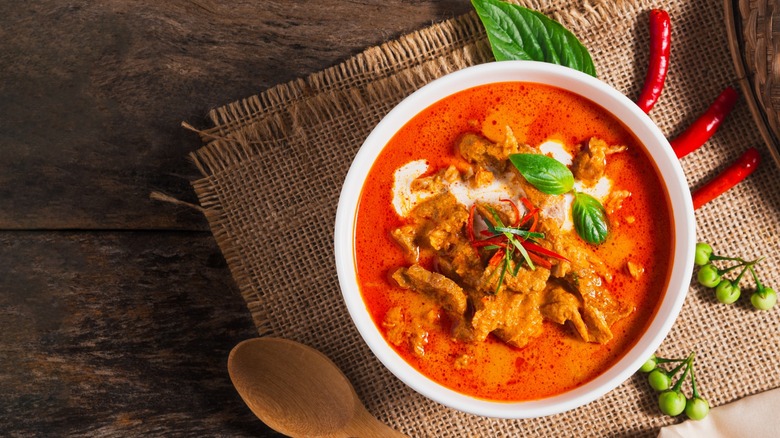 A bowl of Panang curry on a cloth placemat