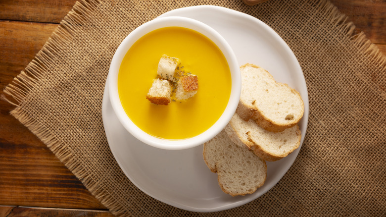 creamy pumpkin bisque in a white bowl