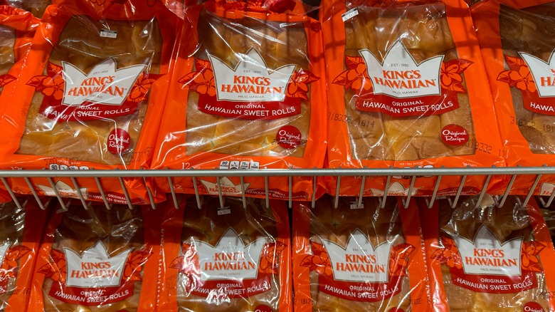 orange bags of kings Hawaiian rolls on grocery store shelves