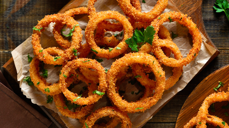 Homemade onion rings over a wooden background