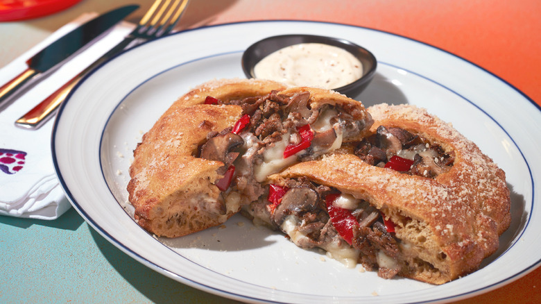 A calzone cut in two on a plate at Mellow Mushroom