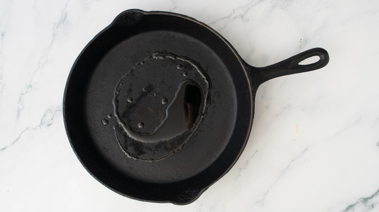 A large cast iron skillet drizzled with olive oil