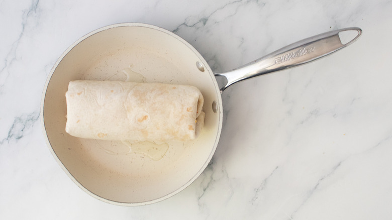 A burrito in a small nonstick skillet