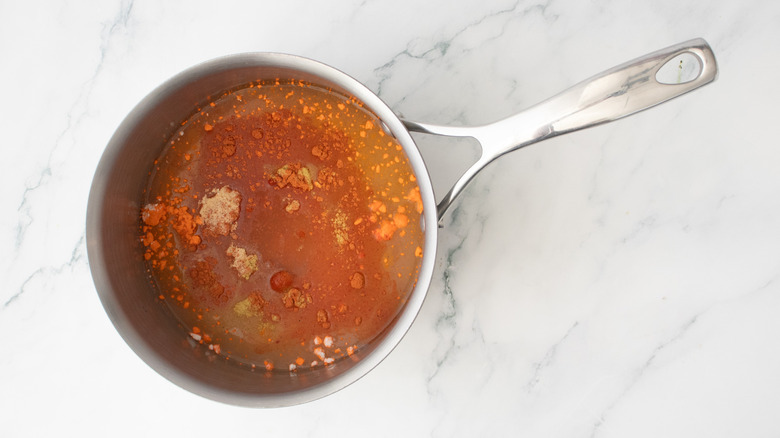 A medium saucepan with an assortment of seasonings