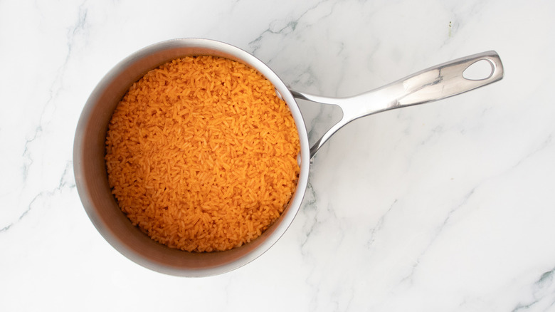 A medium saucepan filled with fluffy red rice