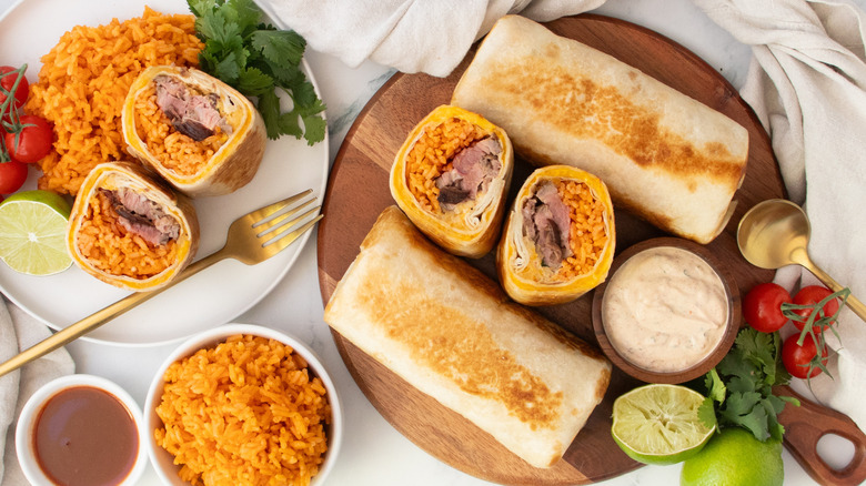 Overhead shot of Quesaritos, whole and halved, with seasoned rice on the side