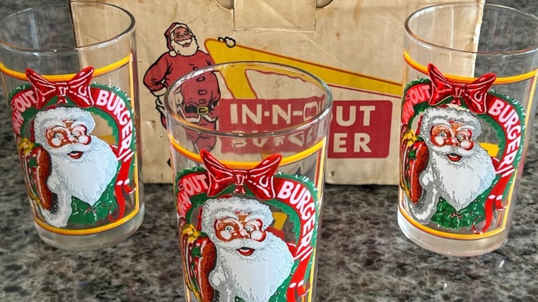 Soda fizzing in drinking glass filled with ice.
