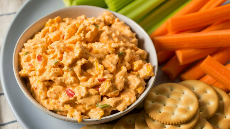Pimento cheese dip with vegetables and crackers