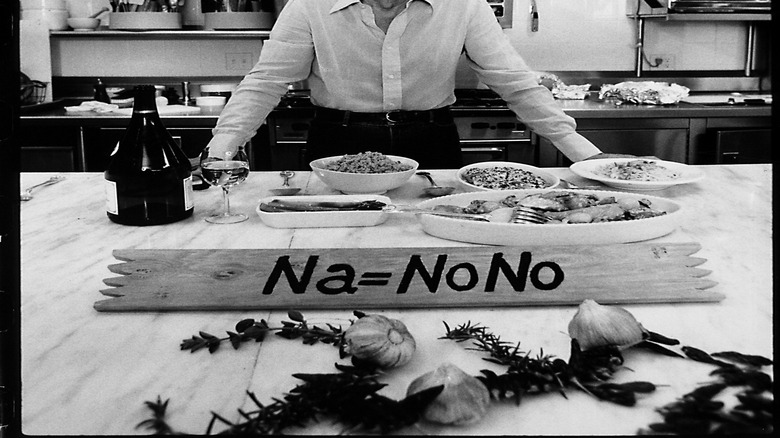 Craig Claiborne in a kitchen in black and white