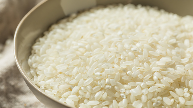 Close-up of dry white Texmati rice in a beige bowl