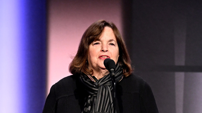 Ina Garten speaking at a microphone